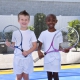 Landon and London on a tennis court